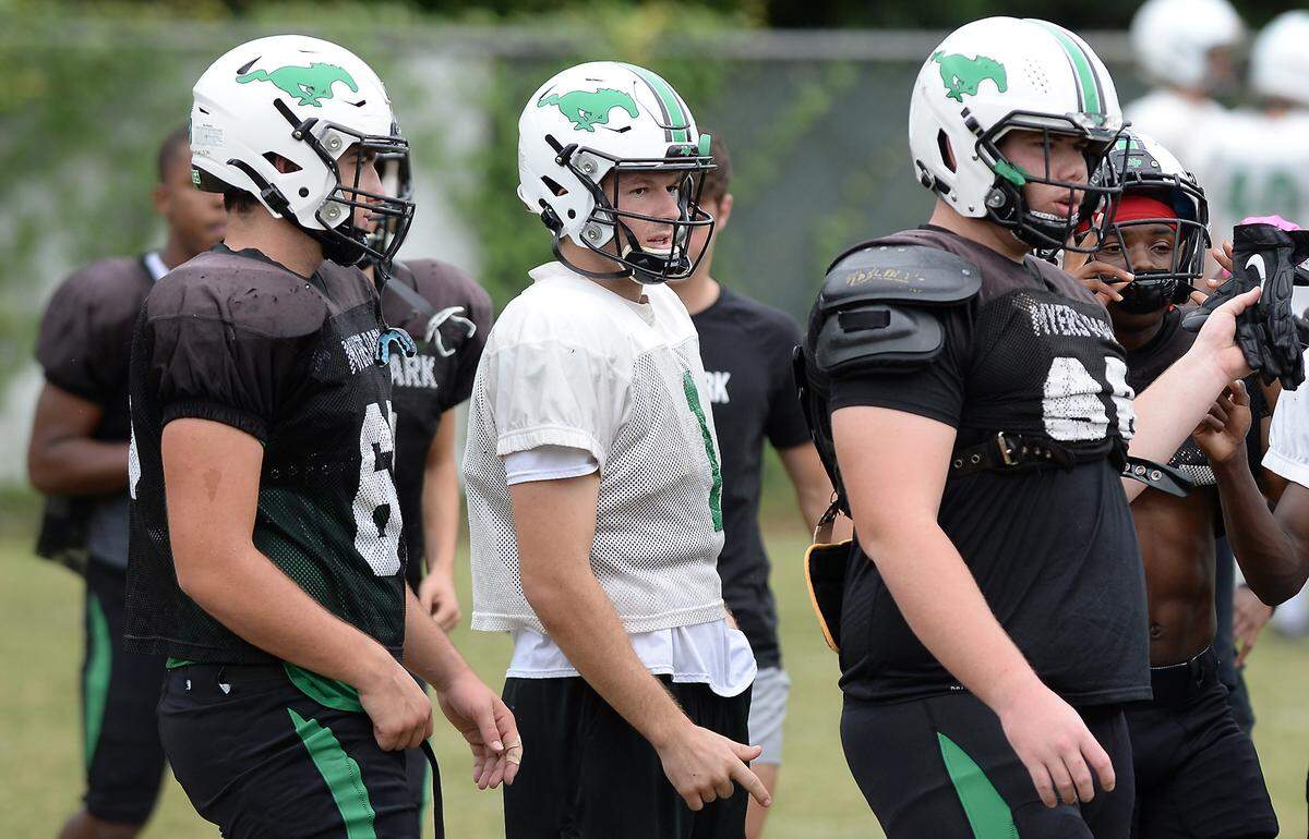 Lucas Lenhoff, center, is the new Myers Park Mustangs quarterback and he is having an outstanding season. Lenhoff has passed for 1,431 yards and 17 touchdowns in five games. He moved to Charlotte from California to play football in the 2020-2021 season.
