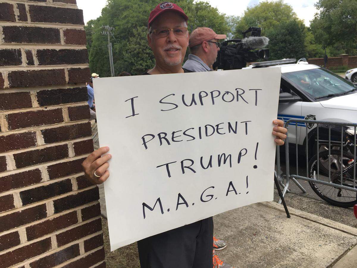 A Trump supporter among those who gathered near Carmel Country Club on Friday, where the president was to attend a fundraiser for two congressional candidates. His appearance also drew sign-wielding protesters, but the scene remained calm.