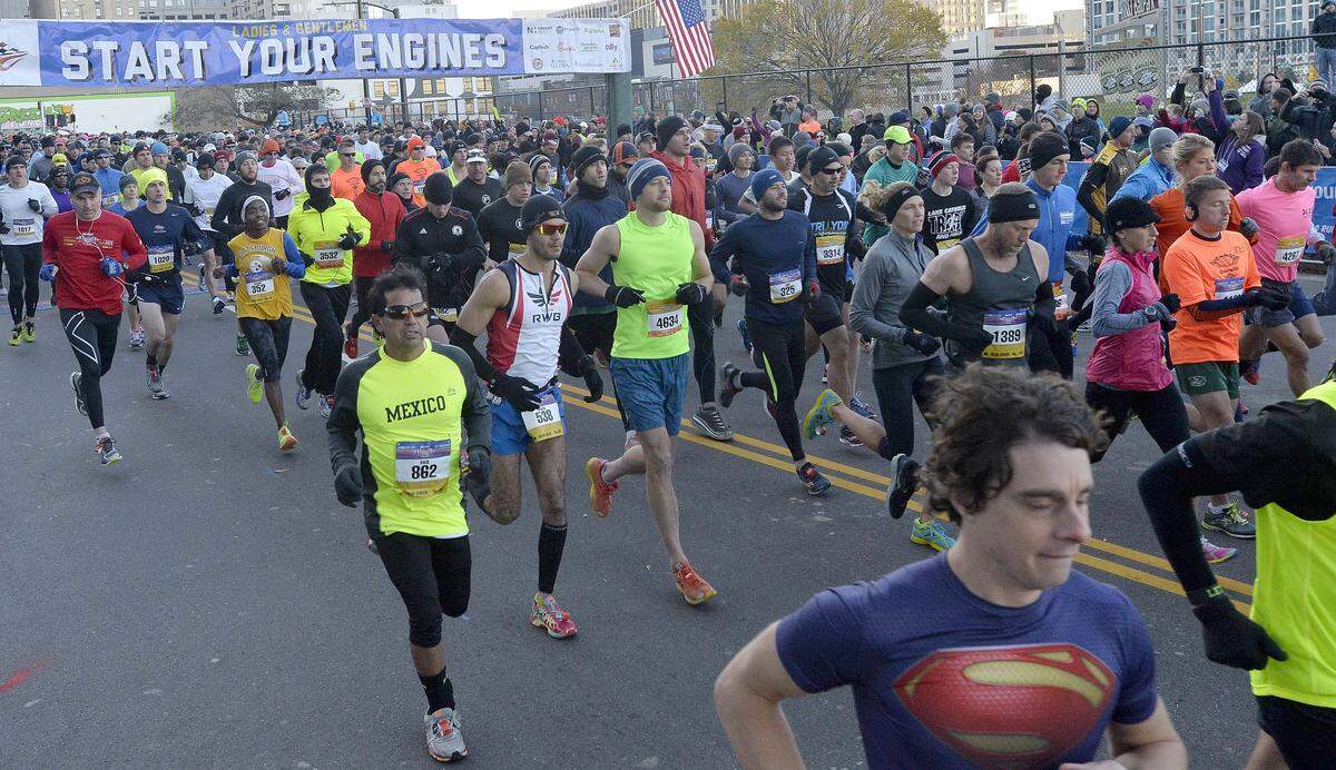 Runners take off at the start of the Thunder Road Marathon and Half-Marathon, both started at 7:45am at the intersection of 4th Street and N. Graham Street in uptown on Nov. 15,2014.