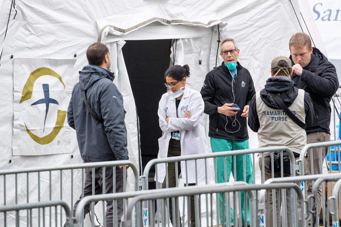 A Samaritan’s Purse crew and medical personnel work on preparing to open a 68 bed emergency field hospital specially equipped with a respiratory unit in New York’s Central Park, Tuesday, March 31, 2020, in New York.