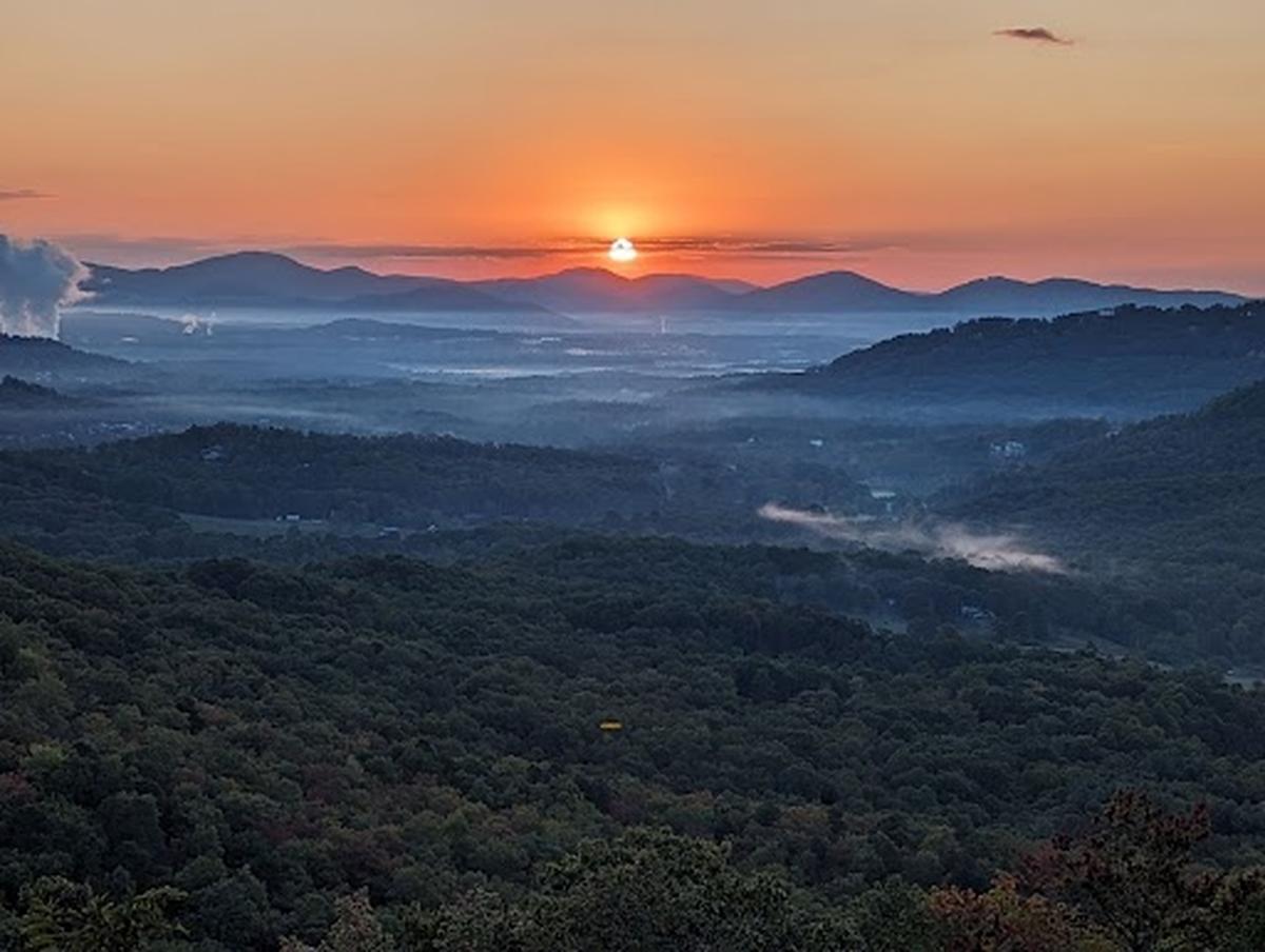 The sun rises above the mountains on Tuesday morning, Oct. 10, 2023, in this picture taken at the Chestnut Cove Overlook in Arden, Buncombe County, on the Blue Ridge Parkway.