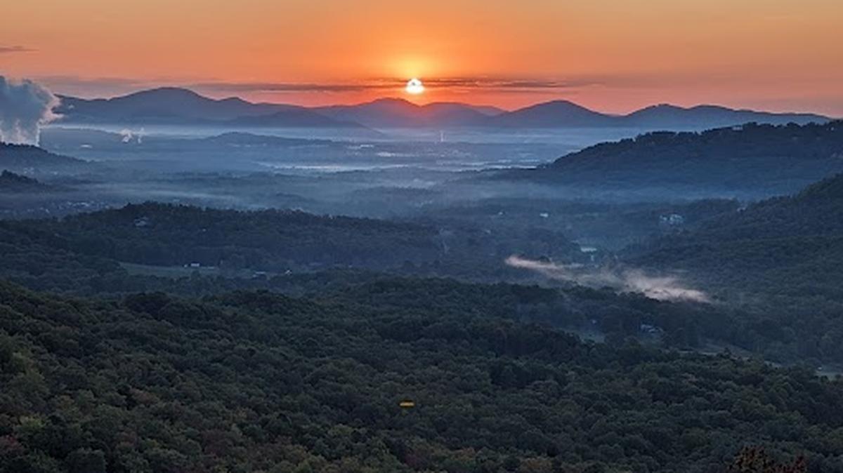 The sun rises above the mountains on Tuesday morning, Oct. 10, 2023, in this picture taken at the Chestnut Cove Overlook in Arden, Buncombe County, on the Blue Ridge Parkway.