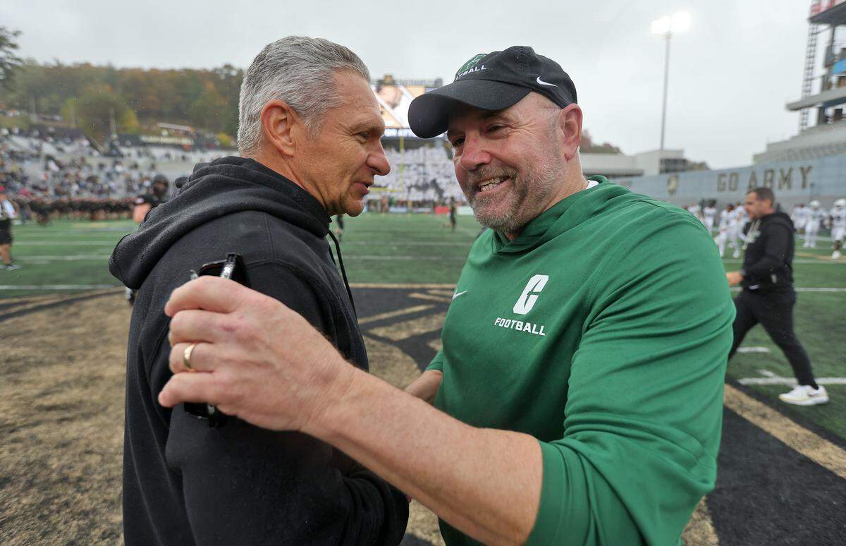 Charlotte 49ers head coach Tim Albin greets Army Black Knights head coach Jeff Monken after Saturday’s 24-7 win by Army at Michie Stadium. 