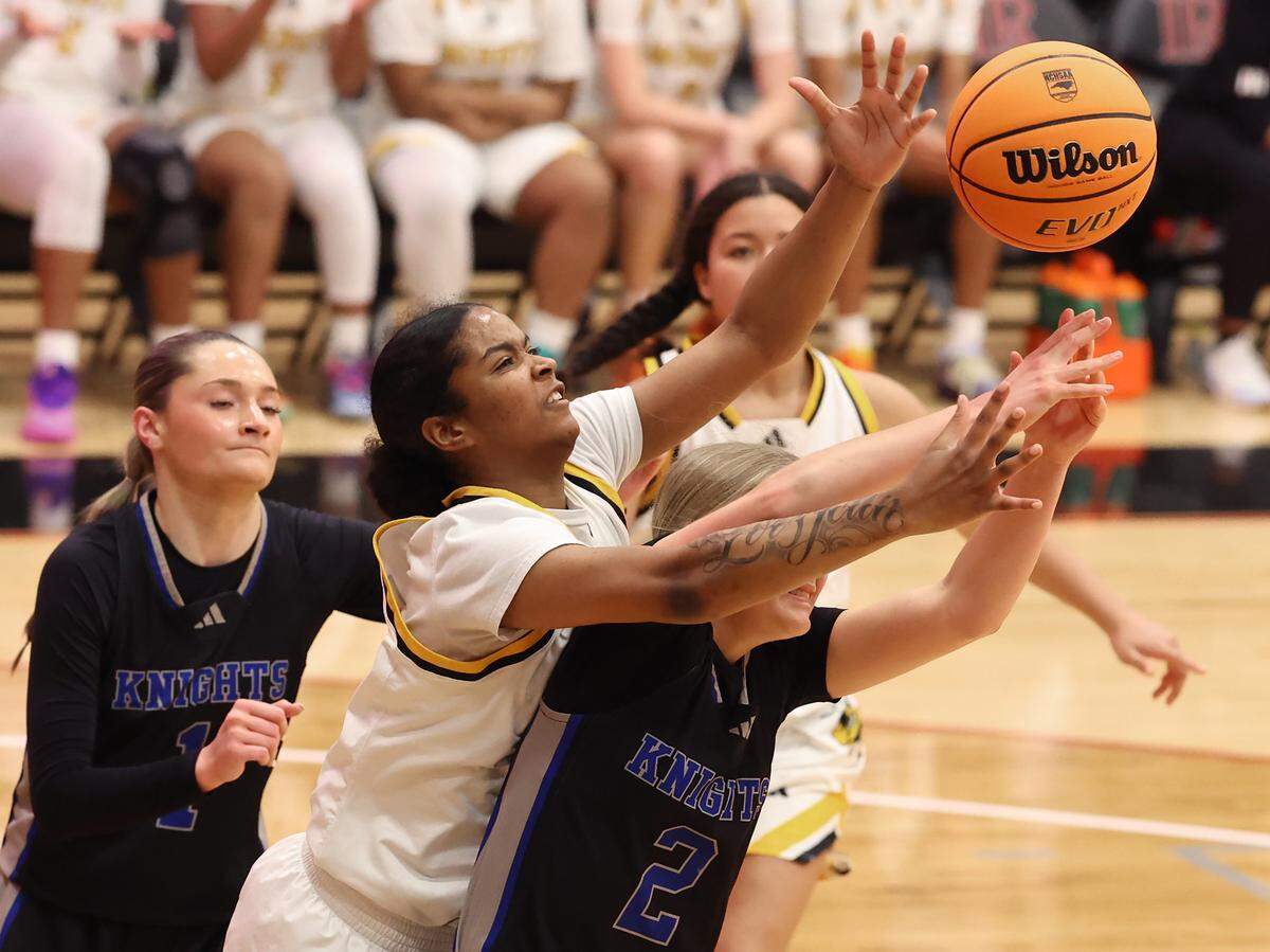 Forest Hills’ Azariya Griffin, center, tries to reach over North Lincoln’s Reese Burch, right, for control of a loose ball during the girls 5A NCHSAA regional championship game at Lenoir-Rhyne University in Hickory, NC on Saturday, March 7, 2026.