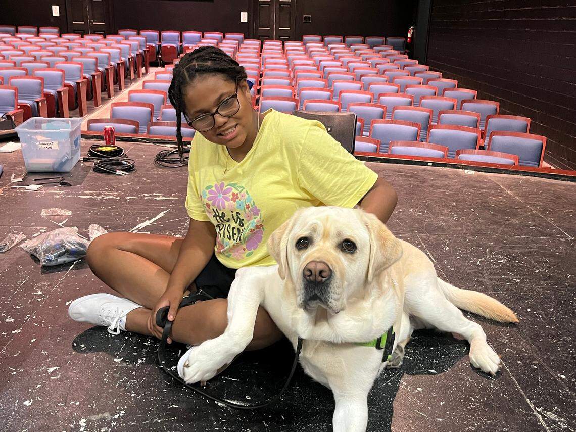 Kate Jewett, who plays Annie, with Timber, a certified therapy dog that plays Sandy in “Annie, Jr.” at Theatre Charlotte.