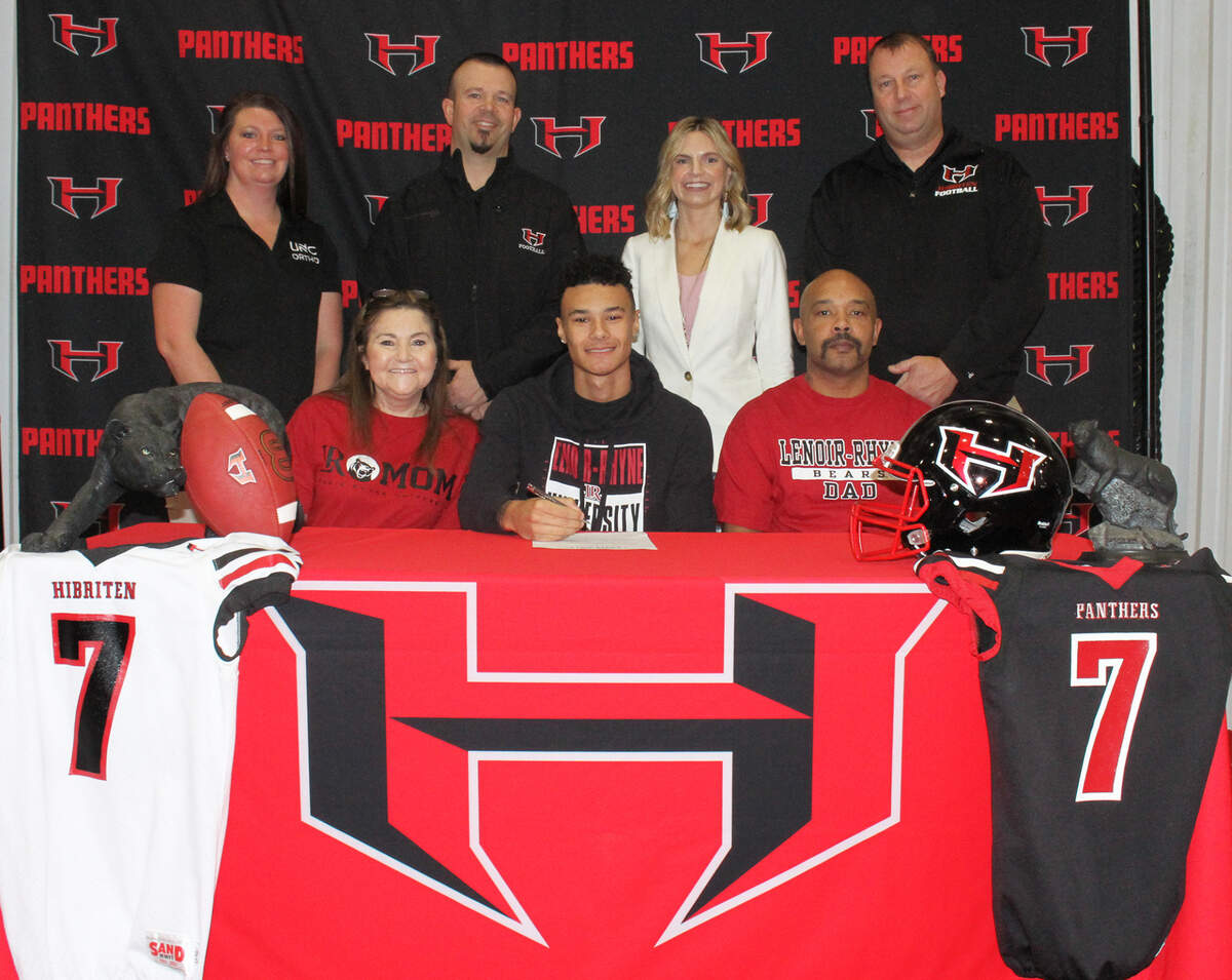 Hibriten’s Coby Wilson signed with Lenoir-Rhyne Wednesday. Front Row: Tina Wilson (mother), Coby Wilson, Moe Wilson (father) Back Row: Chelsea Morris (athletic trainer), Sam Mackey (Head Football Coach), Courtney Wright (principal), Derek Reeves (A.D. and Football Offensive Coordinator)