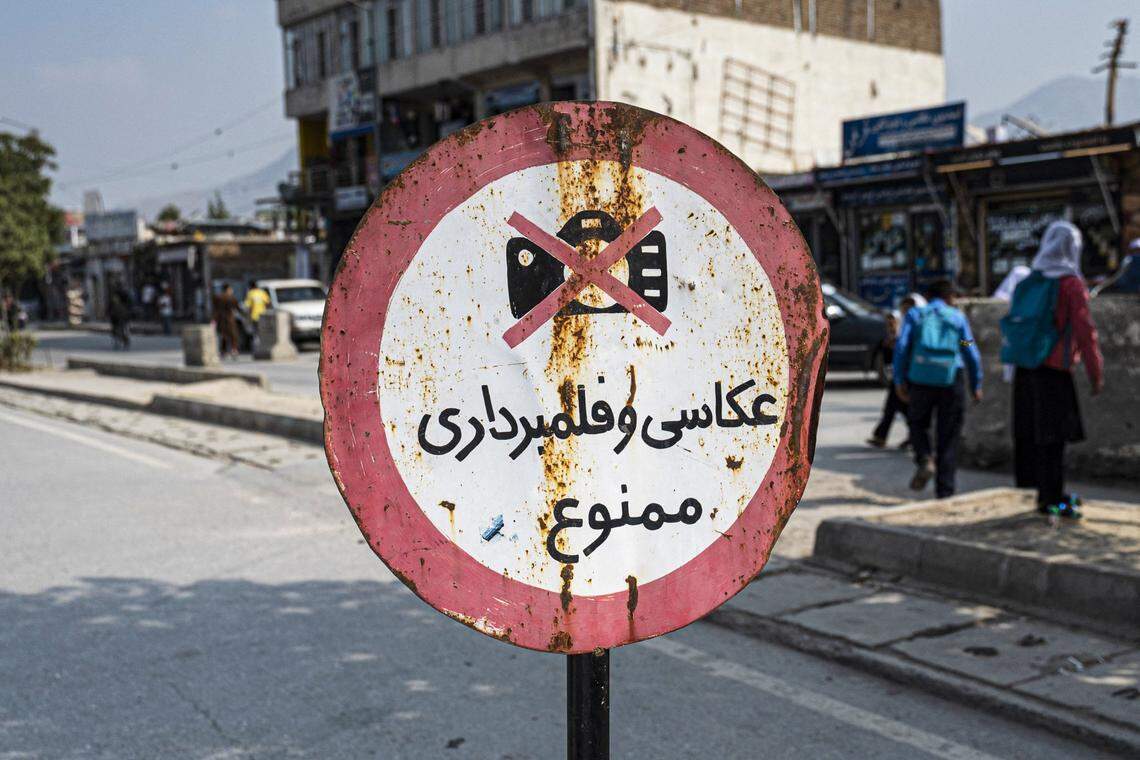 A sign warning ‘Photography and video recording forbidden’ is displayed along a street in Kabul on October 22, 2024. Afghanistan’s Taliban morality ministry had recently tightened its restrictions on women to include a ban on public prayer or recitation from the Quran.