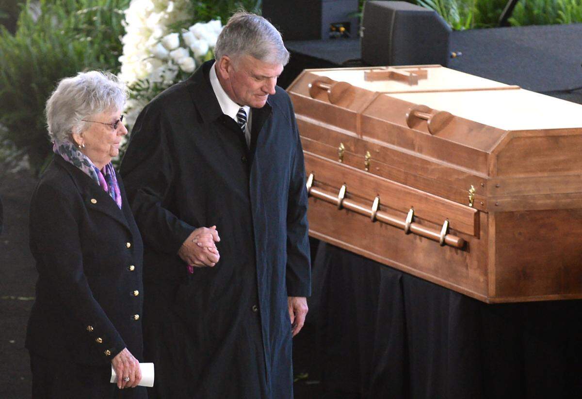 Franklin Graham, right, escorts Jean Ford, the sister of Billy Graham, to the podium for remarks during the Charlotte funeral for Billy Graham on March 2.