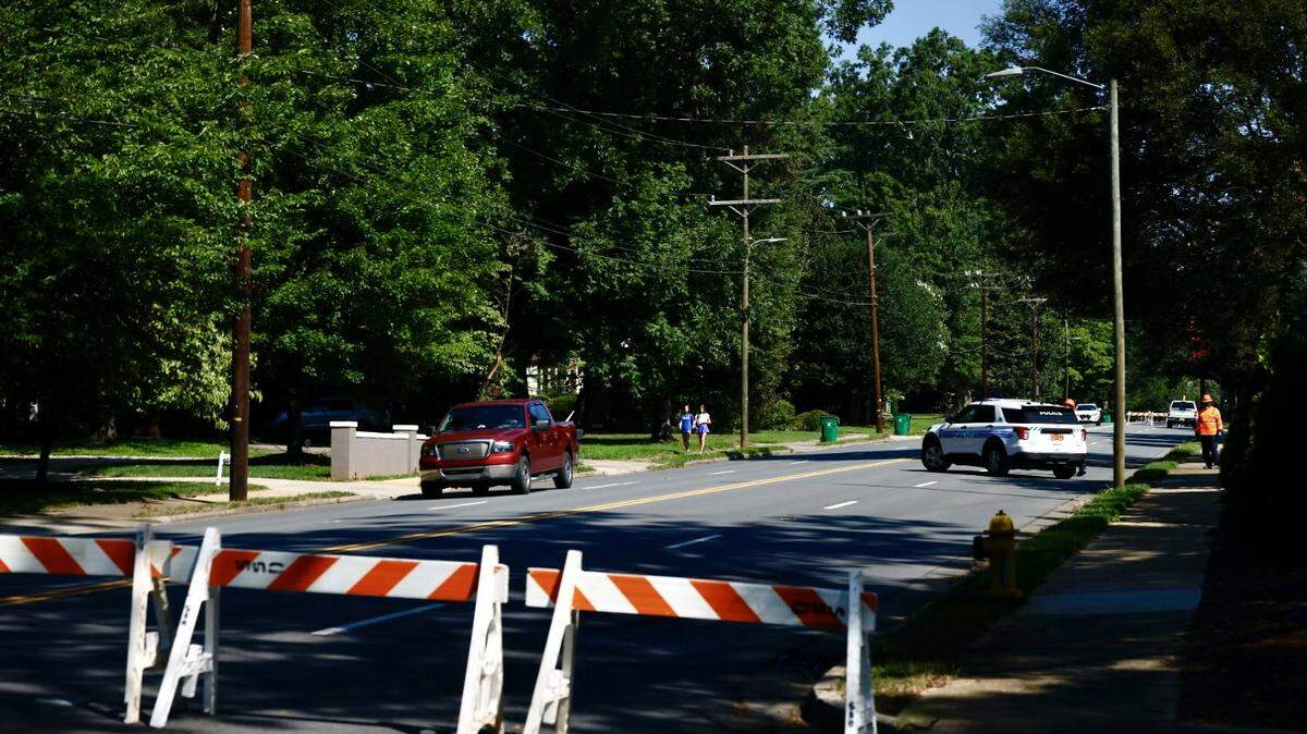 Road barriers prevent traffic from traveling in the 1700 block of Providence Road, where a small sinkhole has developed, on Wednesday, August 14, 2024 in Charlotte.