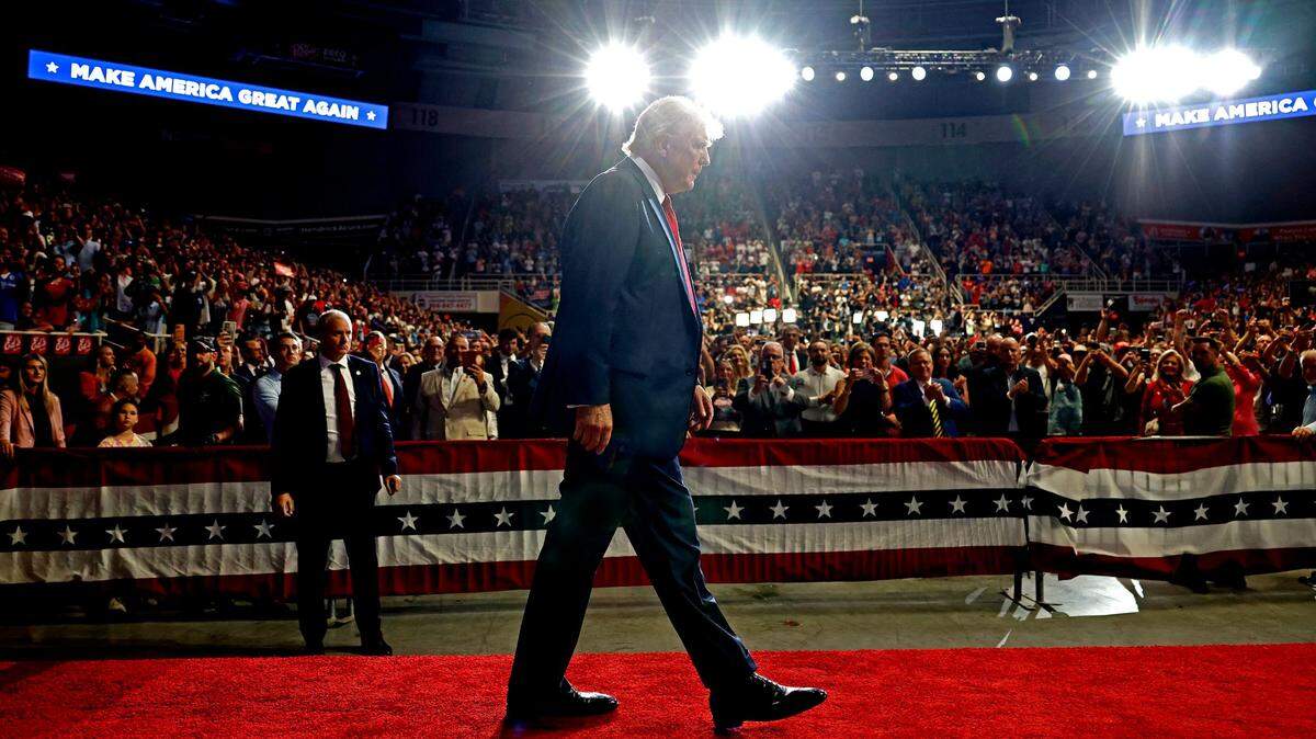 Former President Donald Trump walks to the podium to speak as supporters cheer at Bojangles Coliseum in Charlotte, NC on Wednesday, July 24, 2024.