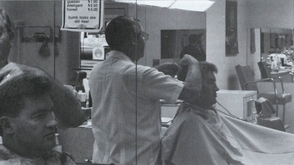 J.B. Kiser trims a client’s hair in his Uptown barbershop, tucked into the corner of the Duke Energy building.