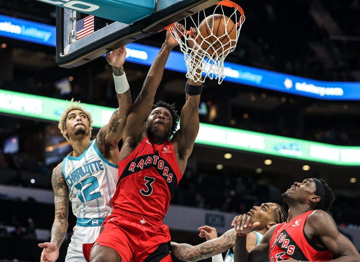 Toronto Raptor OG Anunoby, right, dunks past the Charlotte Hornets’ Kelly Oubre Jr. at the Spectrum Center In Charlotte, N.C., on Monday, February 7, 2022. Anunoby had 20 points in Toronto’s 116-101 win.