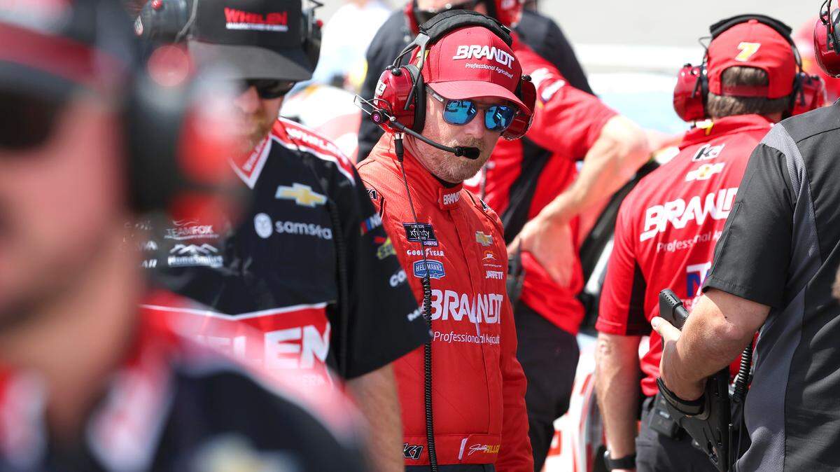 NASCAR Xfinity Series driver Justin Allgaier, center, as another team works on their car prior to qualifying for the North Carolina Education Lottery 250 at Rockingham Speedway on Saturday, April 19, 2025.