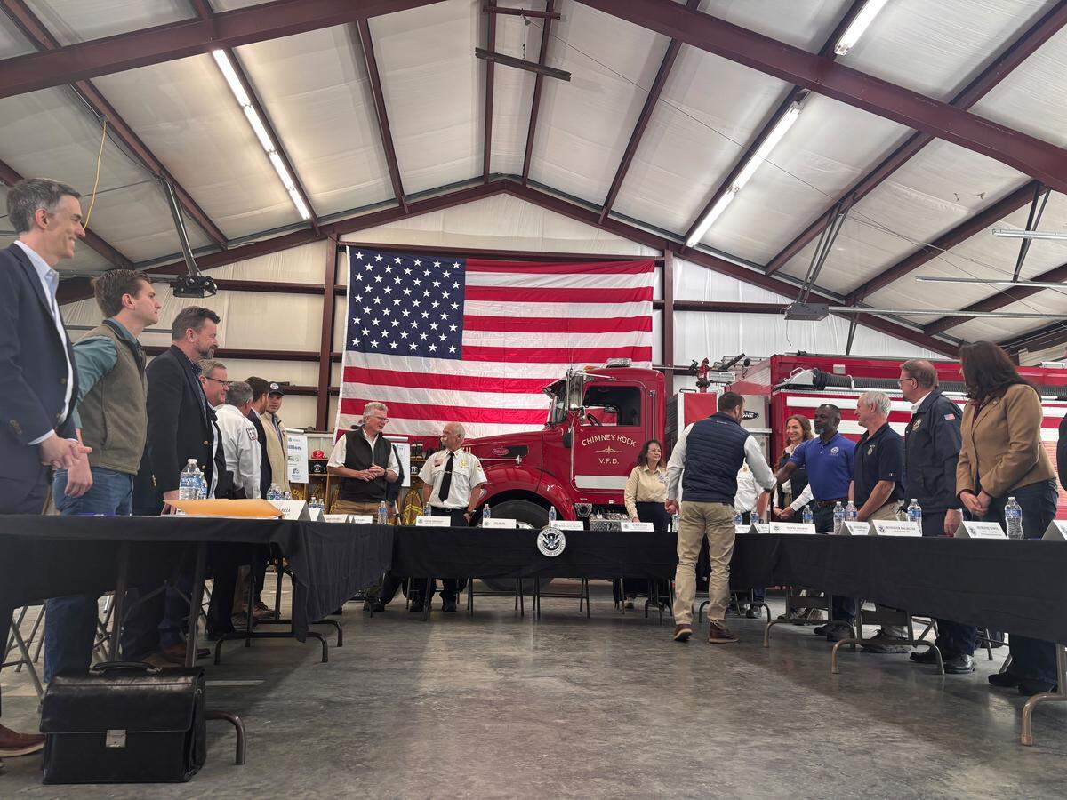 DHS Secretary Markwayne Mullin shakes hands with local and federal officials in Chimney Rock on April 7. Mullin made his first trip as secretary to Western North Carolina to discuss FEMA and survey damage from Hurricane Helene.