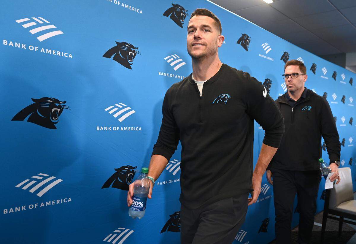 Carolina Panthers head coach Dave Canales, left, and general manager Dan Morgan, right, exit a pre-draft press conference at Bank of America Stadium on Thursday, April 18, 2024.