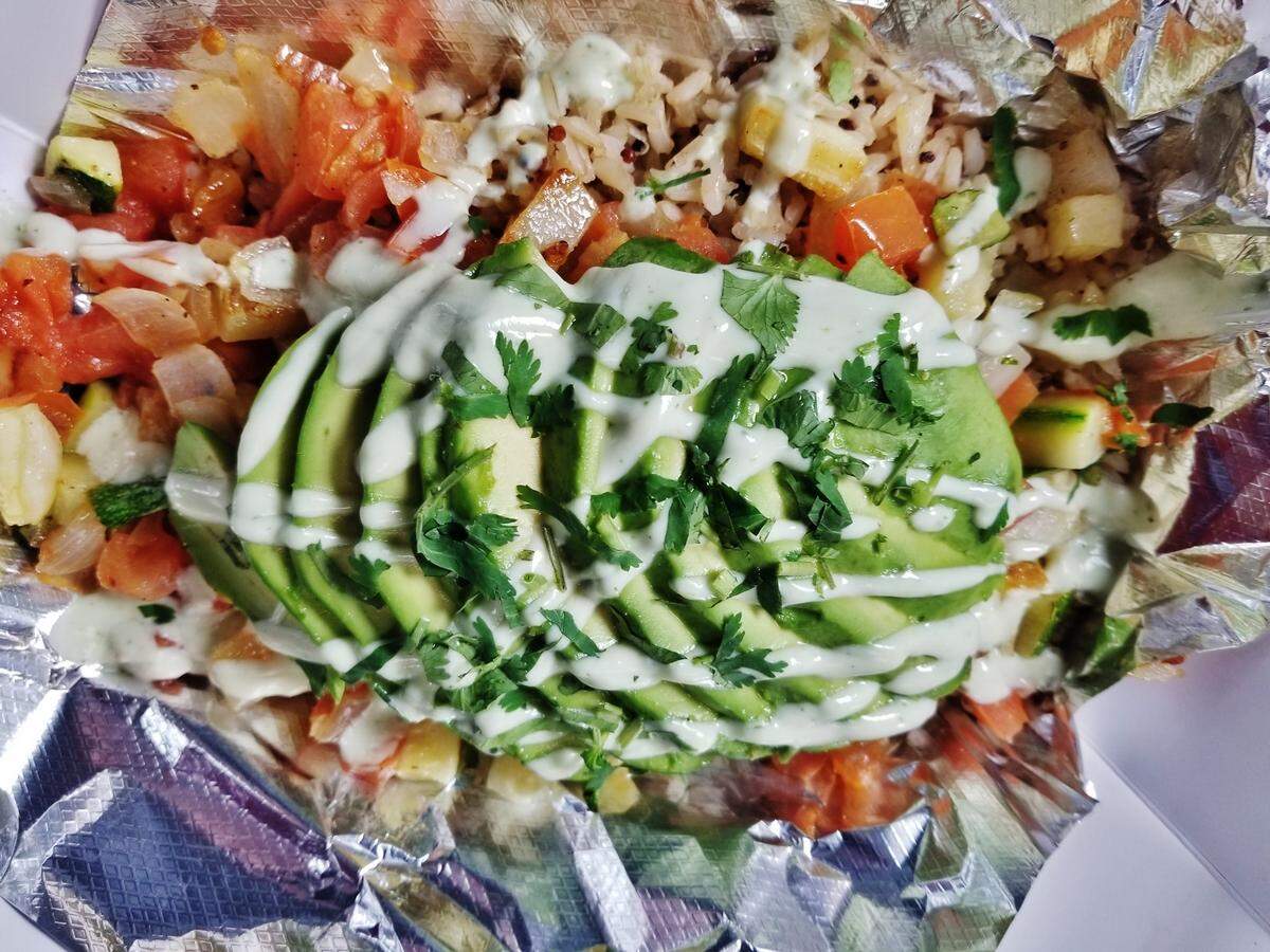 The Quinoa Avocado Bowl at Sabor starts with a bed of quinoa and brown rice and is topped with avocado, grilled vegetables and cilantro lime yogurt sauce.