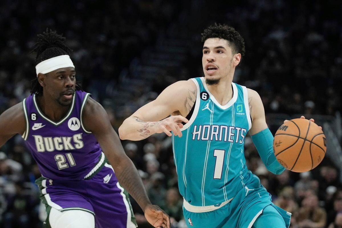 Charlotte Hornets’ LaMelo Ball drives past Milwaukee Bucks’ Jrue Holiday during the first half of an NBA basketball game Friday, Jan. 6, 2023, in Milwaukee. (AP Photo/Morry Gash)