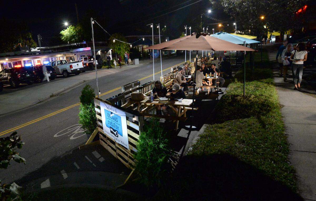 Diners enjoy meals and beverages in a StreetEats area along Thomas Avenue in Charlotte.