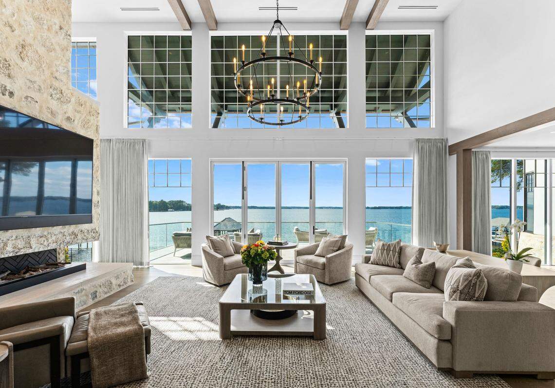 Natural light floods the grand, two-story foyer and sun-drenched salon, where fold-away doors open to a spacious terrace.
