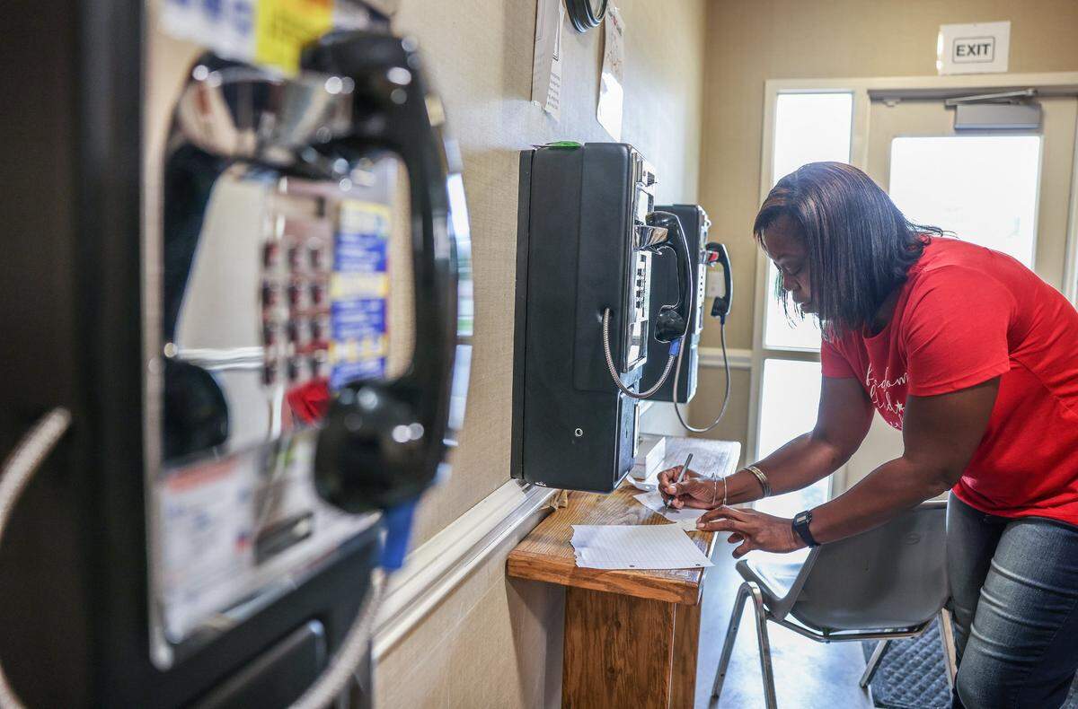 Dravia Price writes her email address down for the residents on her release day at the Center for Community Transitions in Charlotte, on Tuesday, June 29, 2021.