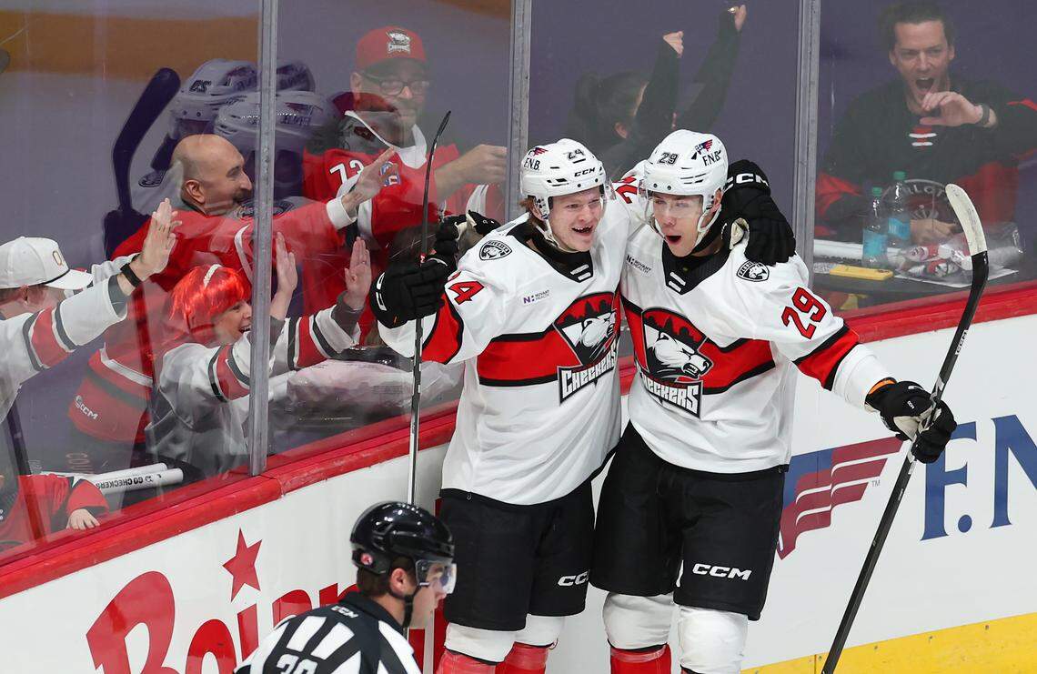 Charlotte Checkers Gracyn Sawchyn, left, is congratulated by teammate Sandis Villains, right, following Sawchyn’s goal against the Iowa Wild on Friday, October 17, 2025 at Bojangles Coliseum in Charlotte, NC. 