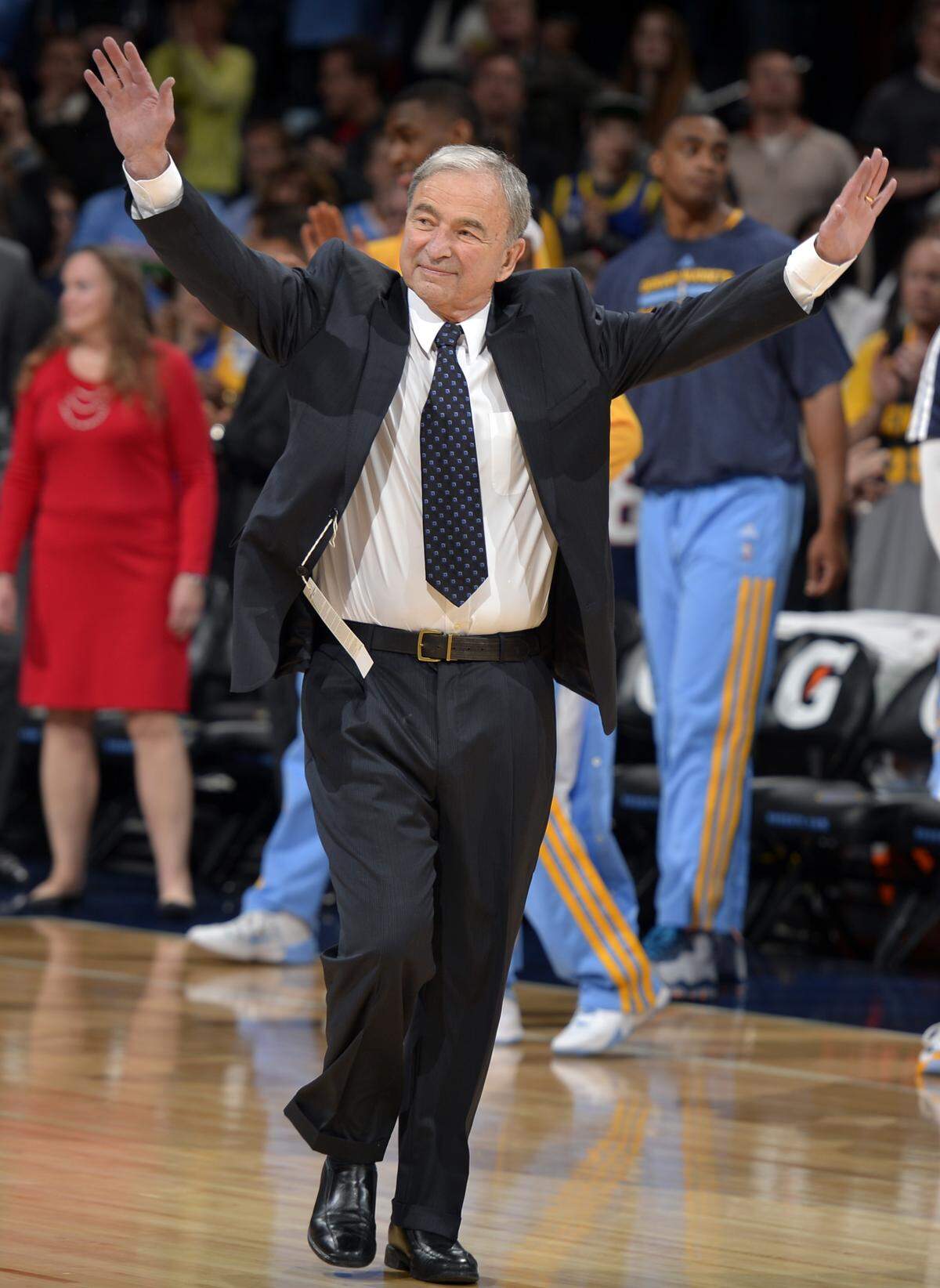 Former Denver Nuggets executive Carl Scheer waves to fans as he is honored before the start of an NBA basketball game in Denver in 2014. Scheer ran both the Nuggets and the Charlotte Hornets during his career, and both those teams have honored him. Scheer, 82, lives in Charlotte and has dementia.