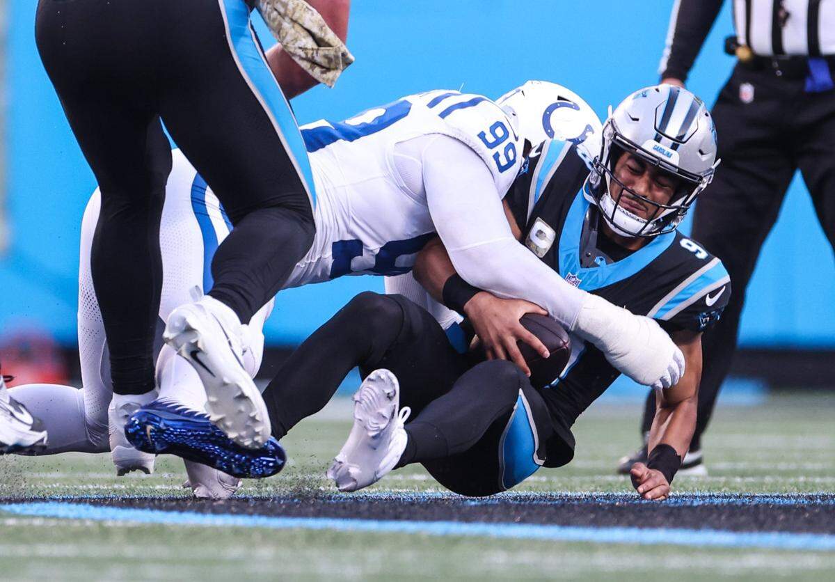 Carolina Panthers quarterback Bryce Young, right, is sacked by Indianapolis Colts defensive tackle DeForest Buckner at the Bank of America Stadium in Charlotte, N.C., on Sunday, November 5, 2023.
