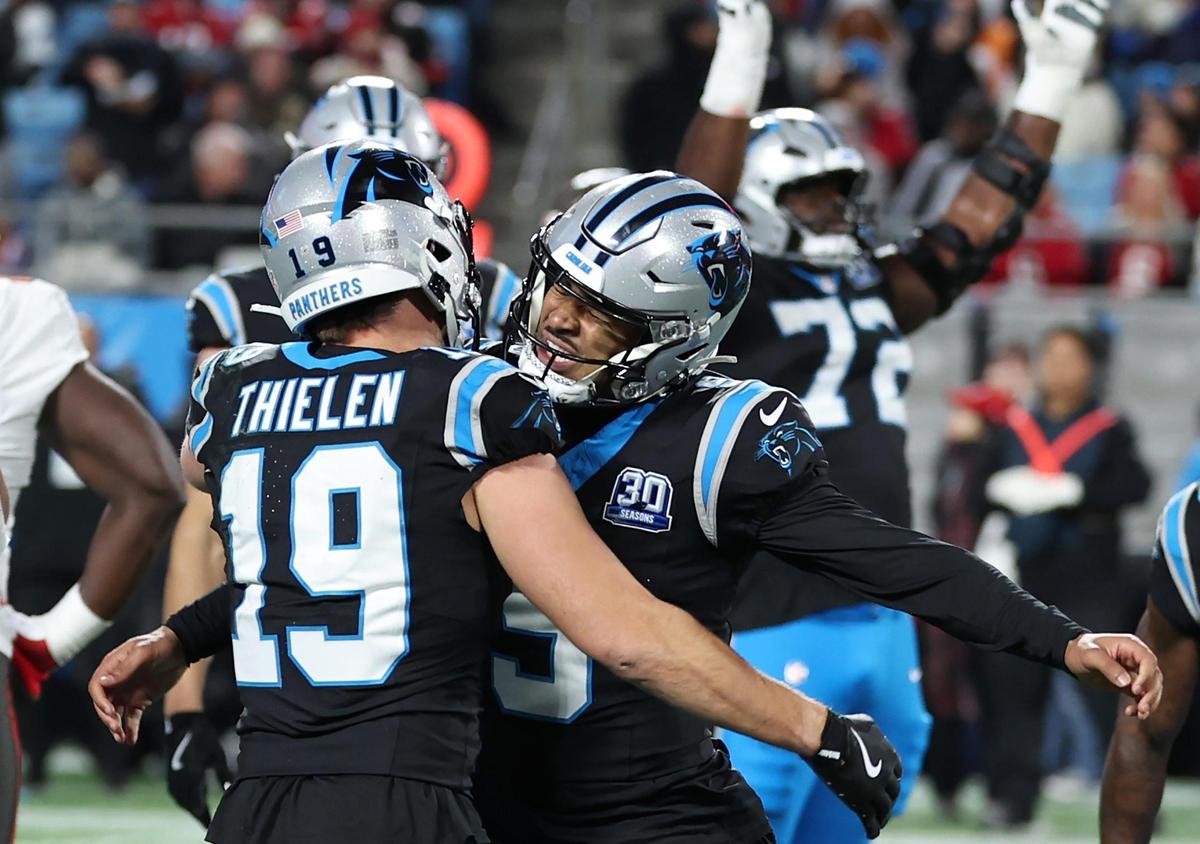 Carolina Panthers quarterback Bryce Young, right, congratulates wide receiver Adam Thielen on what was believed to be a touchdown pass reception in the closing moments of first half action against the Tampa Bay Buccaneers at Bank of America Stadium in Charlotte, NC on Sunday, December 1, 2024. The call was initially ruled a touchdown but after a review was overturned.