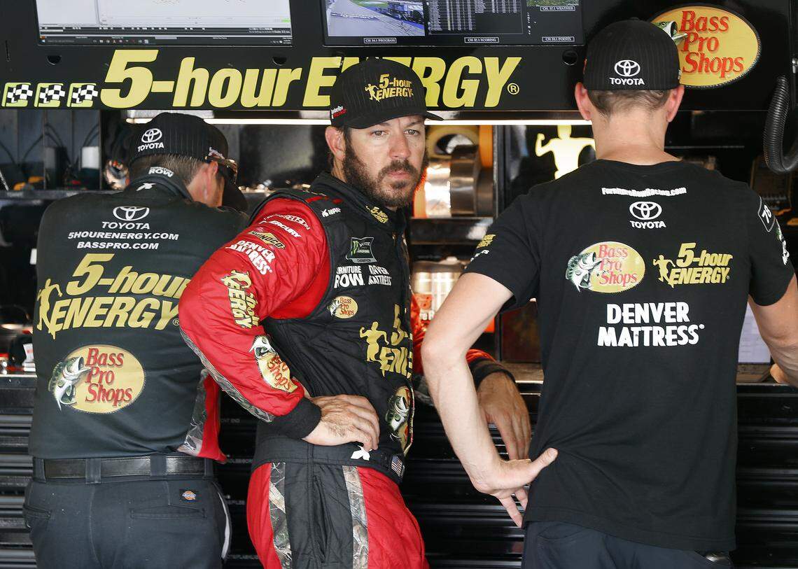 Martin Truex Jr. watches his crew work during practice for a NASCAR Cup Series auto race at Michigan International Speedway in Brooklyn, Mich., Saturday, Aug. 11, 2018. (AP Photo/Paul Sancya)