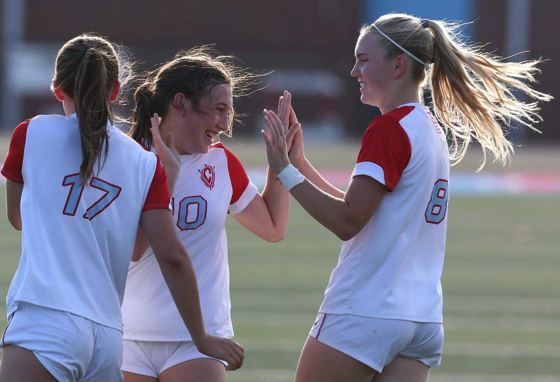 Charlotte Catholic’s Anne Gonyea, Kinleigh Thornton and Mary Martin Spinner celebrate a goal against Piedmont on April 15, 2026. Charlotte Catholic is ranked No. 4 in the nation by MaxPreps.