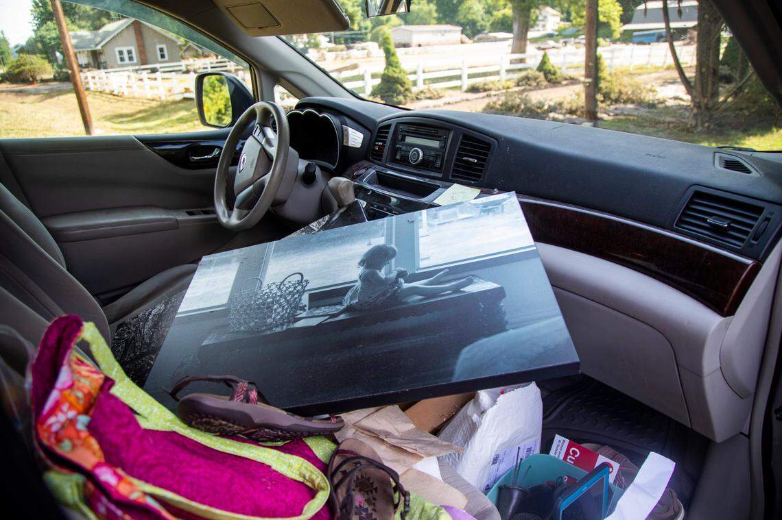 A family photo salvaged from Donella Pressley’s flooded home sits in the front seat of her van in Bethel Thursday, Aug. 19, 2021 after remnants from Tropical Storm Fred caused flooding in parts of Western North Carolina Tuesday. Search and rescue teams continue to search the area as 20 people are missing and 2 people were found dead.