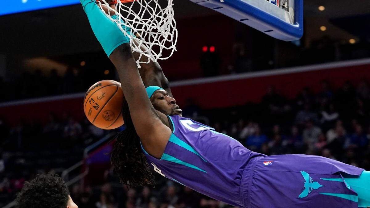 Charlotte Hornets Montrezl Harrell (7) dunks on Detroit Pistons guard Killian Hayes (7) in the first half of an NBA basketball game in Detroit, Friday, Feb. 11, 2022. (AP Photo/Paul Sancya)