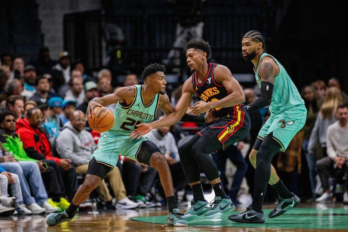 Charlotte Hornets forward Brandon Miller (24) drives against Atlanta Hawks forward De’Andre Hunter (12) during the second quarter at Spectrum Center.