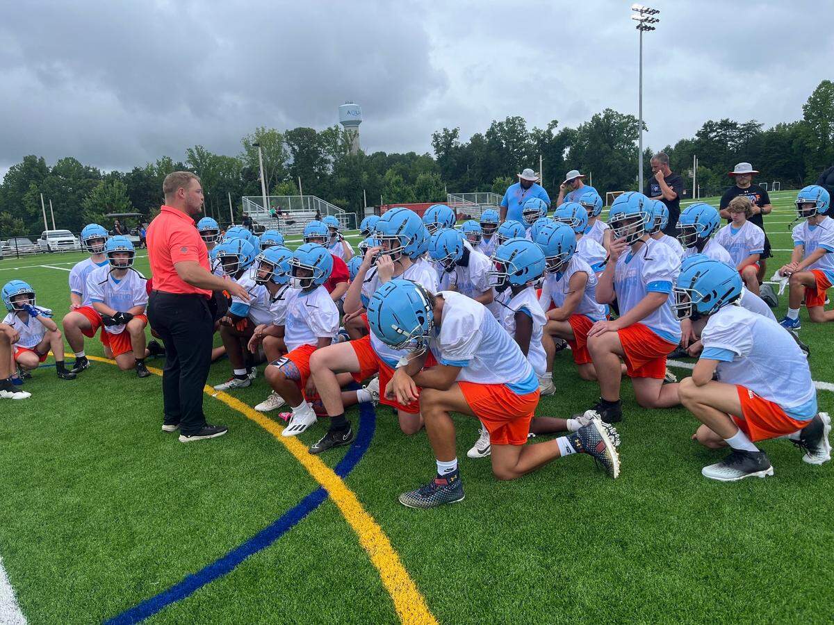 Head coach Chris Redding speaks to the Ballantyne Ridge Wolves following a July 25, 2024, scrimmage at Langtree Charter Academy in Mooresville.