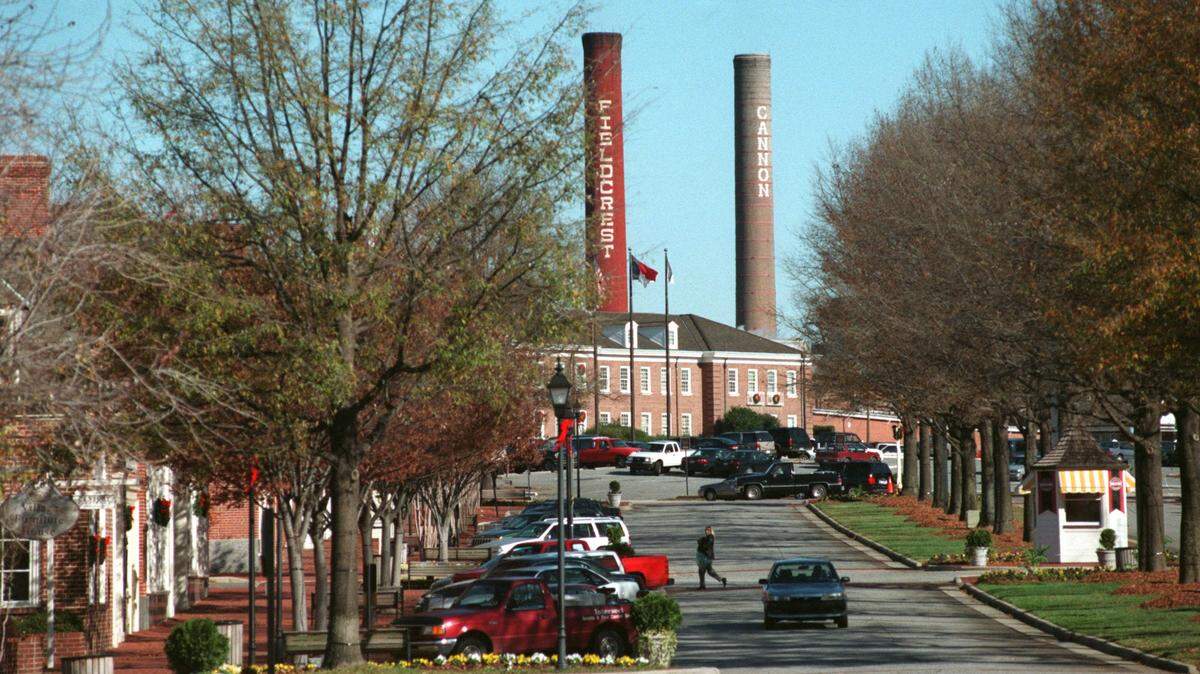 Cannon Mills Co. descendants and Atrium Health have settled the battle over the $17 million family trust in N.C. Business Court. Stacks from Fieldcrest Cannon mills rise above Cannon Village in Kannapolis in this 1999 file photo.