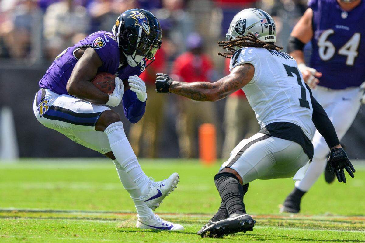 Sep 15, 2024; Baltimore, Maryland, USA; Baltimore Ravens wide receiver Nelson Agholor (15) runs with the ball as Las Vegas Raiders safety Tre'von Moehrig (7) defends during the second half at M&T Bank Stadium. Mandatory Credit: Reggie Hildred-Imagn Images