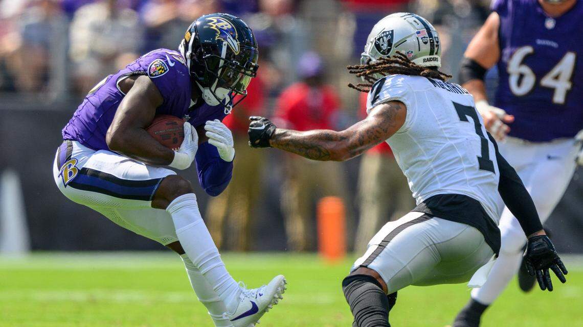 Sep 15, 2024; Baltimore, Maryland, USA; Baltimore Ravens wide receiver Nelson Agholor (15) runs with the ball as Las Vegas Raiders safety Tre'von Moehrig (7) defends during the second half at M&T Bank Stadium. Mandatory Credit: Reggie Hildred-Imagn Images