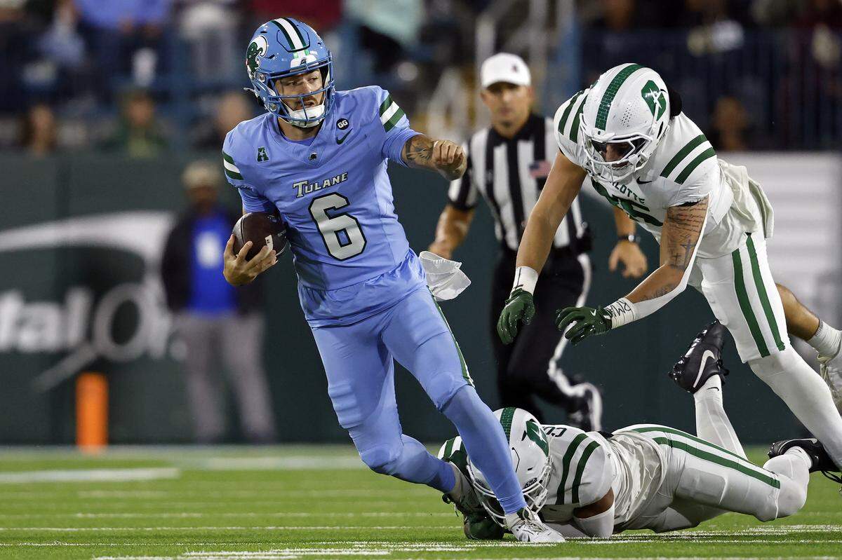 Tulane quarterback Brendan Sullivan (6) is tripped up by defensive back Caleb Curtain of the Charlotte 49ers during the first half at Yulman Stadium on Nov. 29, 2025 in New Orleans, Louisiana.
