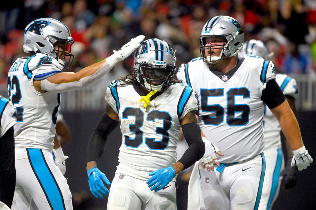 Carolina Panthers running back D’Onta Foreman (33) is congratulated by Tommy Tremble, left, and Bradley Bozeman (56) after scoring during the first half of an NFL football game against the Atlanta Falcons Sunday, Oct. 30, 2022, in Atlanta. (AP Photo/John Amis)