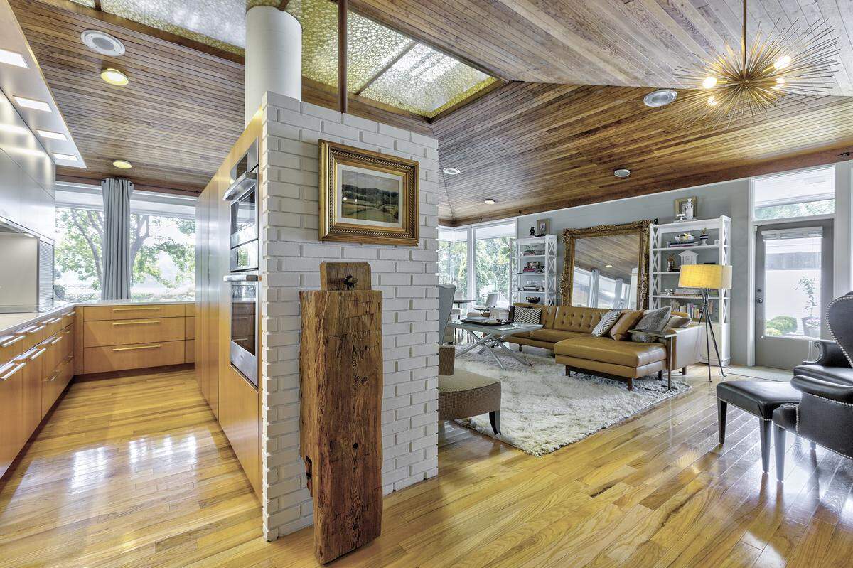 Light fills the living area and kitchen in this classic midcentury modern ranch home on the Catawba River