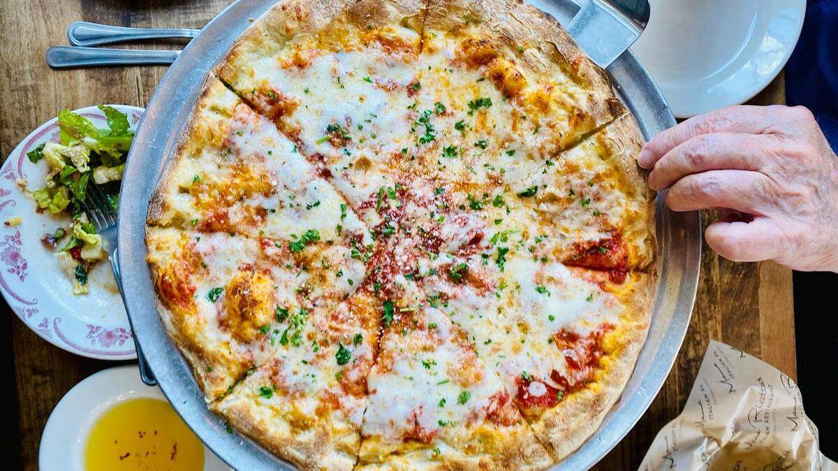 Mama Ricotta’s pizza is a New Haven style with a thin crust that cooked in a wood-burning oven. Shown here is its White Pizza, with fresh garlic, olive oil, and ricotta cheese topped with mozzarella, Romano, and sautéed spinach.