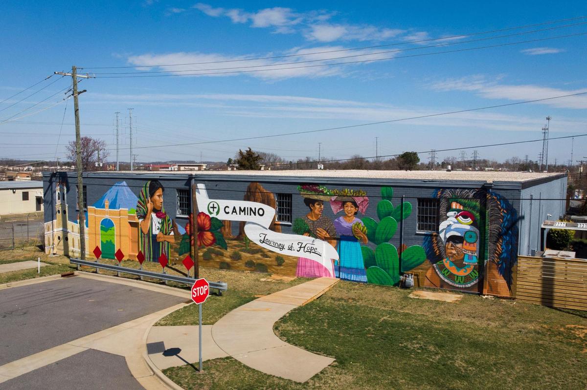 A mural from artist Randall Kane titled “Journey of Hope” adorns the wall of a Camino Health Center building on Stetson Drive in Charlotte, N.C., Thursday, March 3, 2022.