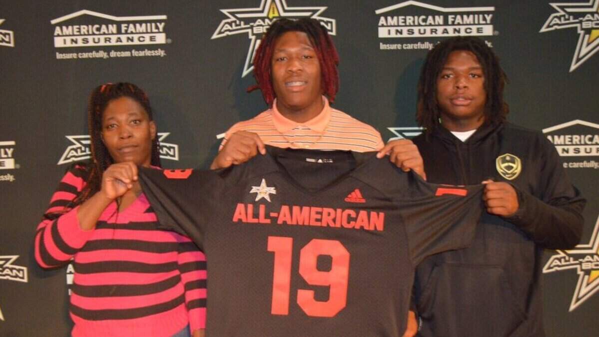 Harding High’s Quavaris Crouch, center, received his US Army All-American jersey in a special ceremony at school Thursday. Crouch said he will announce his college decision Jan. 5 during the All-American game in San Antonio, Texas.