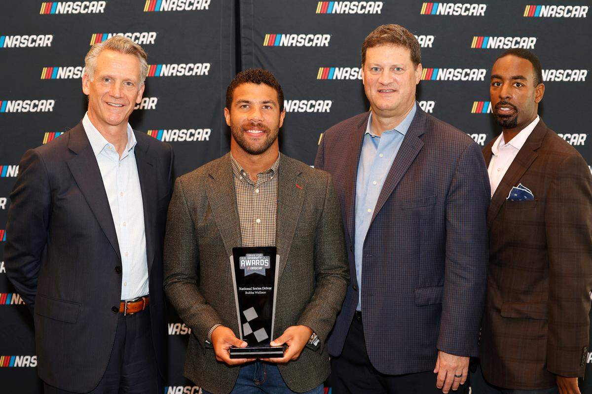NASCAR president Steve Phelps, Cup driver Bubba Wallace, NASCAR EVP chief racing development officer Steve O’Donnell and NASCAR VP of diversity and inclusion Brandon Thompson at the NASCAR Hall of Fame on October 07, 2021 in Charlotte, North Carolina.