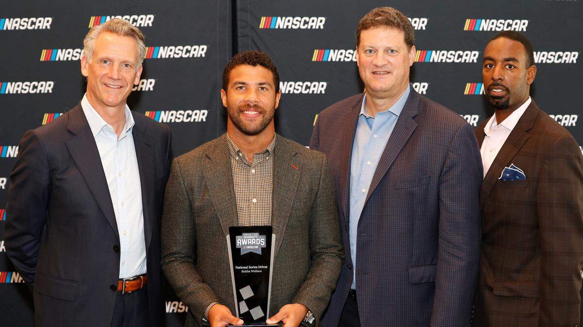 NASCAR president Steve Phelps, Cup driver Bubba Wallace, NASCAR EVP chief racing development officer Steve O’Donnell and NASCAR VP of diversity and inclusion Brandon Thompson at the NASCAR Hall of Fame on October 07, 2021 in Charlotte, North Carolina.