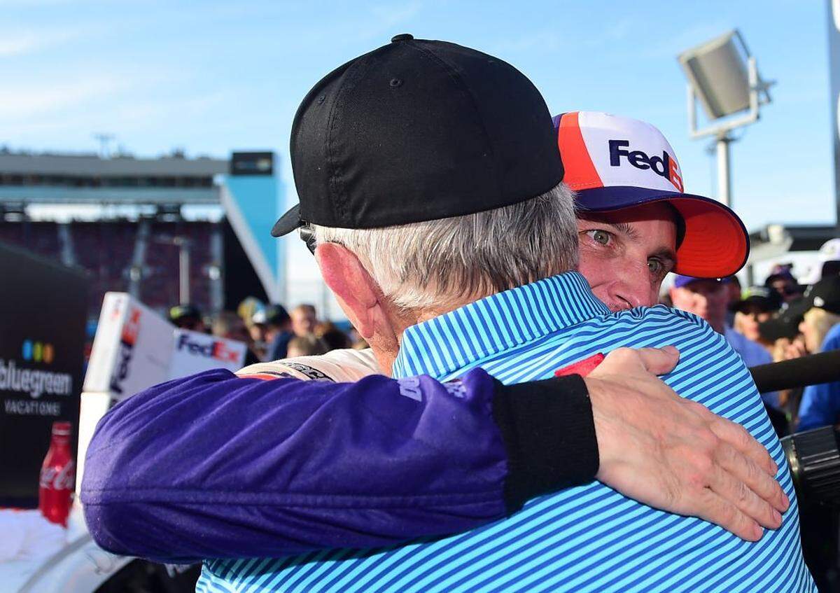 Denny Hamlin, driver of the No. 11 FedEx Ground Toyota, is congratulated in Victory Lane by team owner Joe Gibbs after winning the 2019 Monster Energy NASCAR Cup Series Bluegreen Vacations 500 at ISM Raceway in Avondale, Arizona.