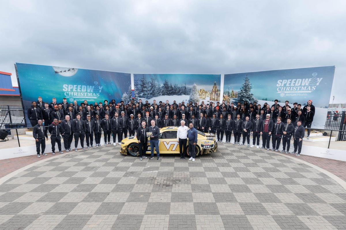 The Hokies from Virginia Tech pose for a team photo before taking ‘Hot Laps’ at 160mph at Charlotte Motor Speedway December 31, 2024. Minnesota and Virginia Tech will play in the Duke’s Mayo Bowl on January 3, 2025 at 7:30 at Bank of American Stadium.
