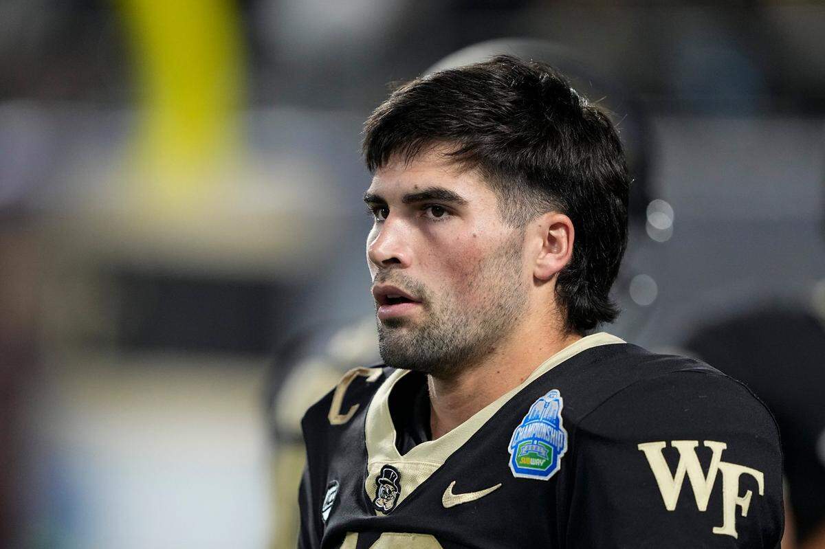 Wake Forest quarterback Sam Hartman watches during warmups before the Atlantic Coast Conference championship NCAA college football game against Pittsburgh Saturday, Dec. 4, 2021, in Charlotte, N.C.