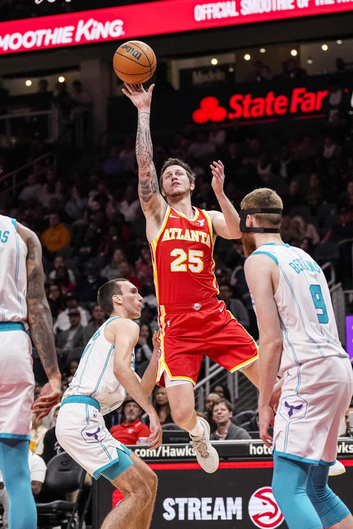 Atlanta Hawks guard Garrison Mathews (25) shoots over Charlotte Hornets forward Aleksej Pokusevski (17) during the first half at State Farm Arena.