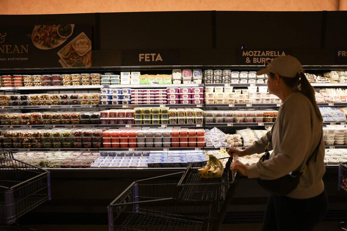 A customer looks at a long display of cheese and Olives during a shopping trip to Wegmans on Wednesday, Oct. 14, 2026 at the store in Charlotte.